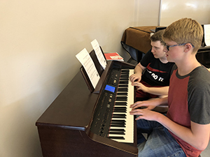 Students practicing the piano in the music appreciation class